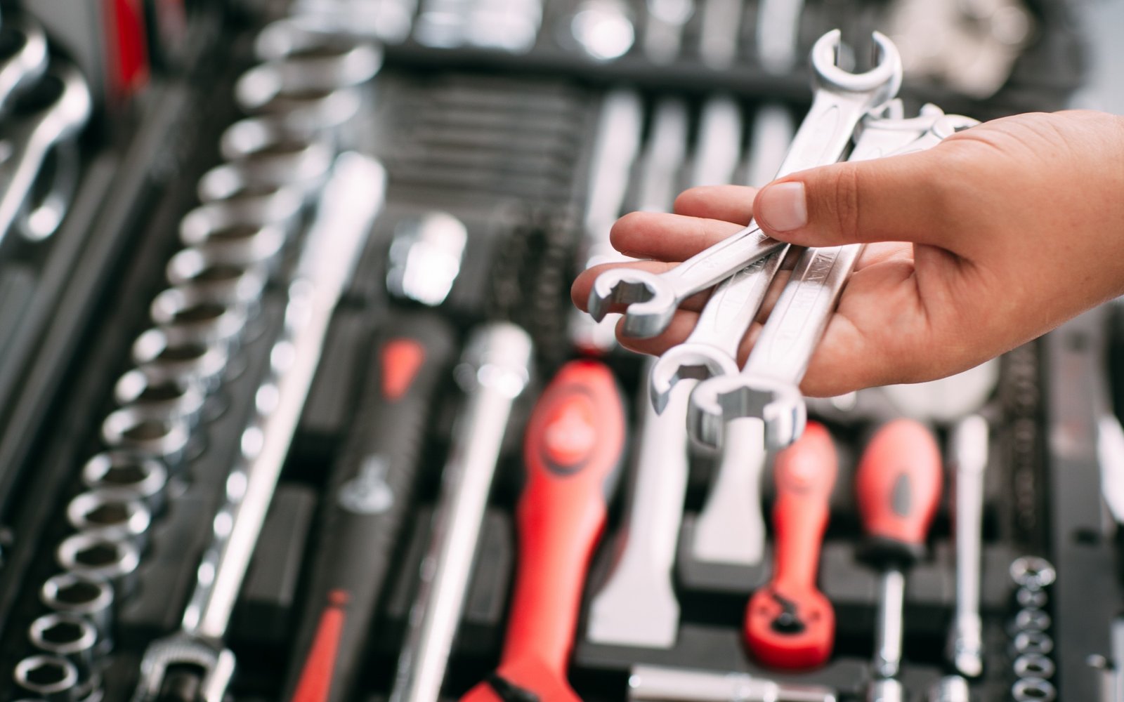 spanners-wrenches-tools-in-hands-repair-concepts-tools-box.jpg
